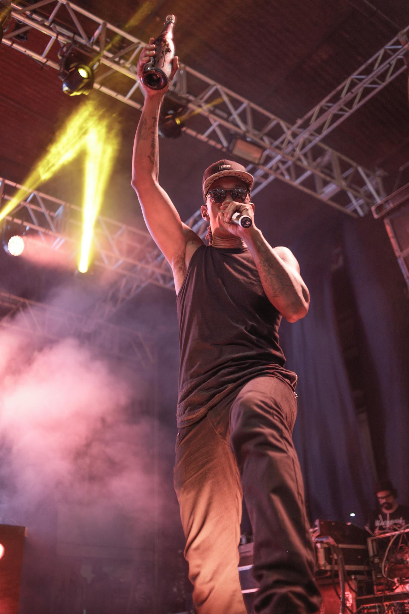 Dynamic rapper on stage with vibrant lighting, delivering an engaging performance in Brazil.